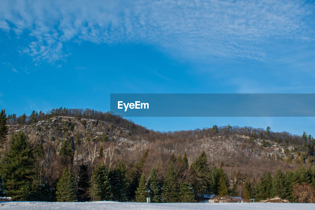 Scenic view of mountains against blue sky