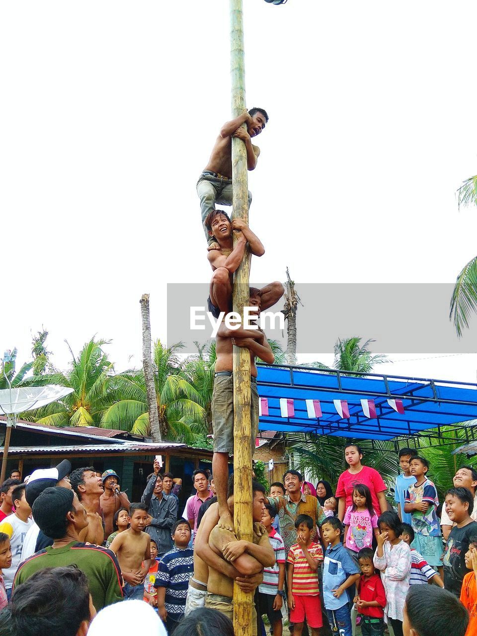 GROUP OF PEOPLE AGAINST CLEAR SKY