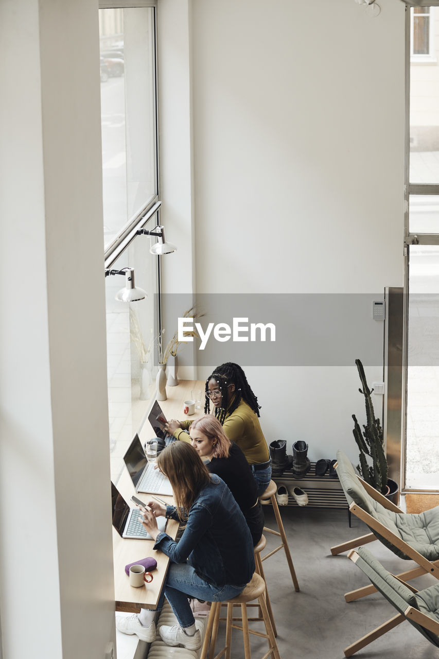 High angle view of businesswomen working together in office