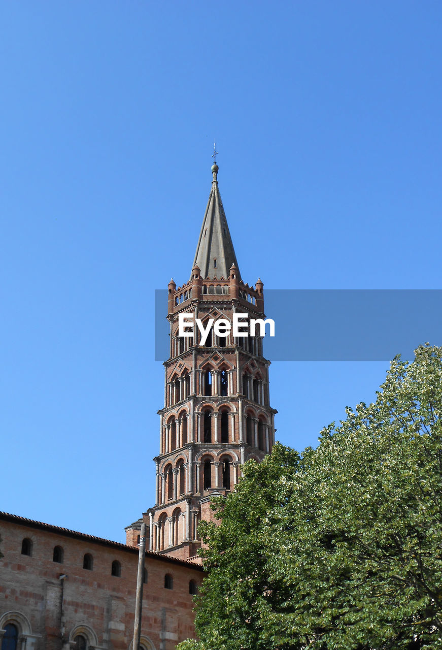 Low angle view of tower against clear blue sky