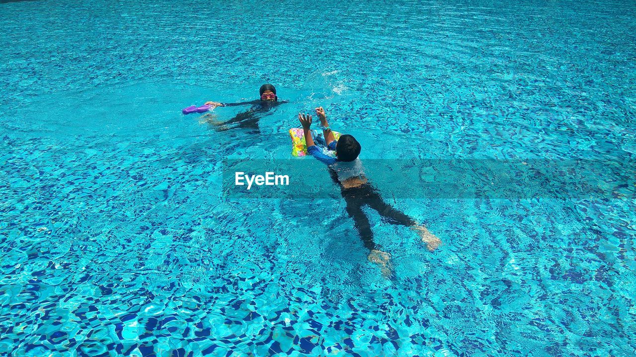 High angle view of people swimming in pool