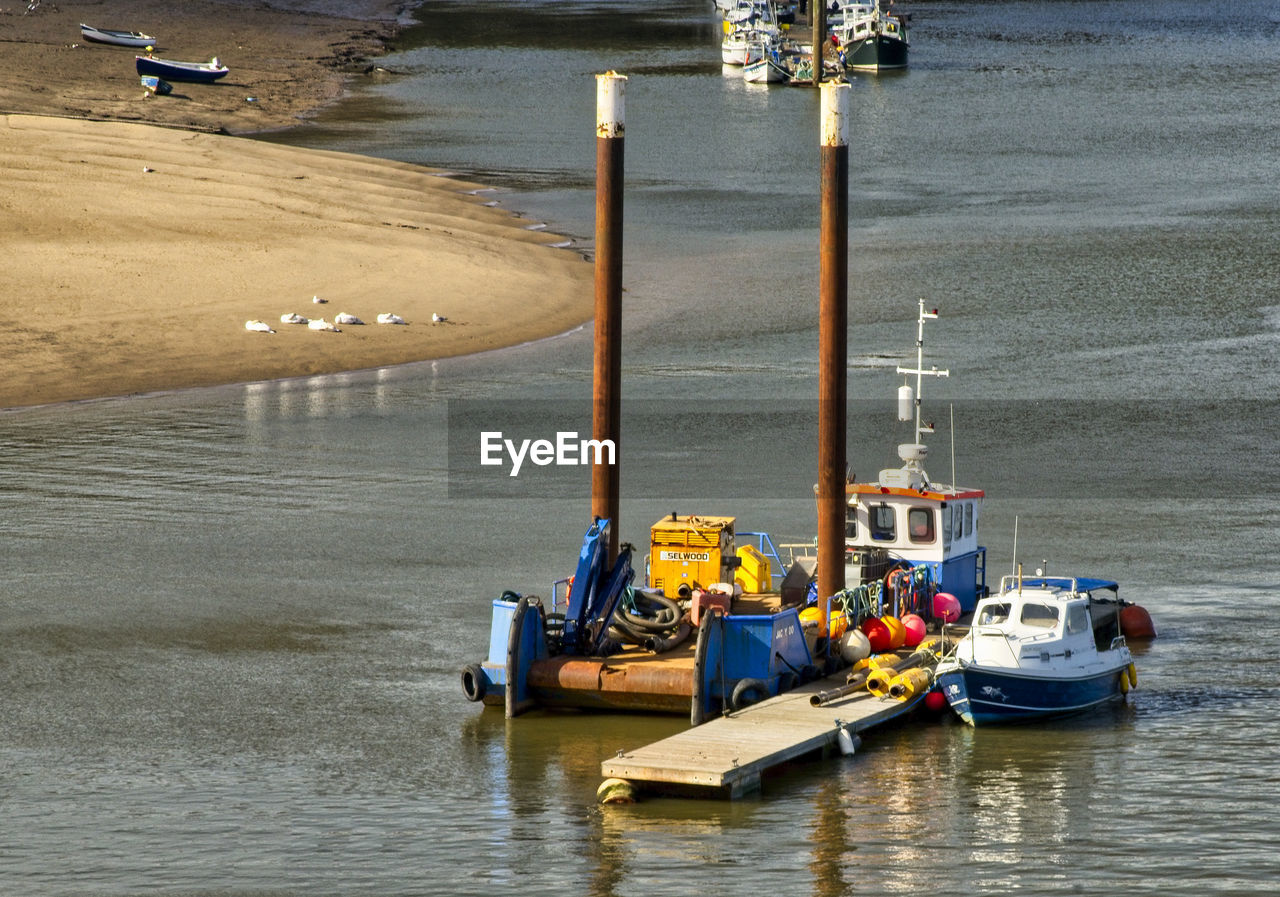 HIGH ANGLE VIEW OF SHIP MOORED ON SHORE