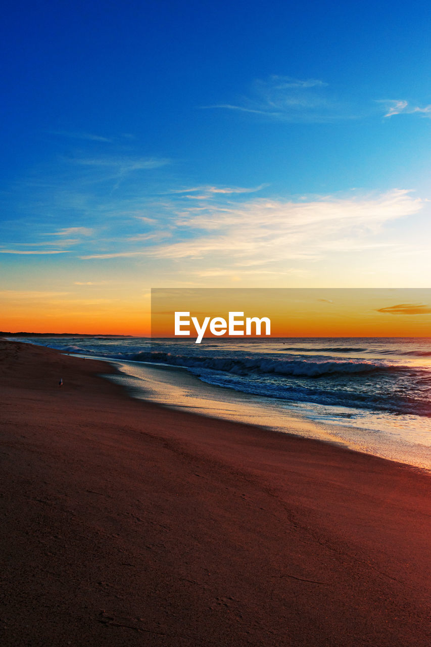 Scenic view of beach against sky during sunset