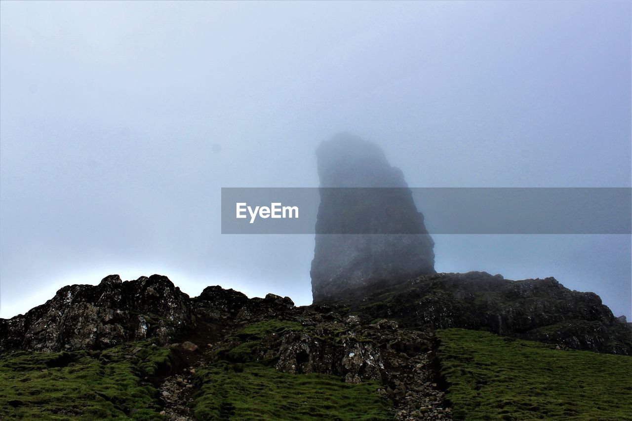 mountain, sky, rock, nature, environment, scenics - nature, beauty in nature, land, landscape, cliff, no people, travel destinations, terrain, rock formation, fog, cloud, travel, plant, outdoors, non-urban scene, sea, tranquility, tourism, geology, coast, plateau, tranquil scene, day