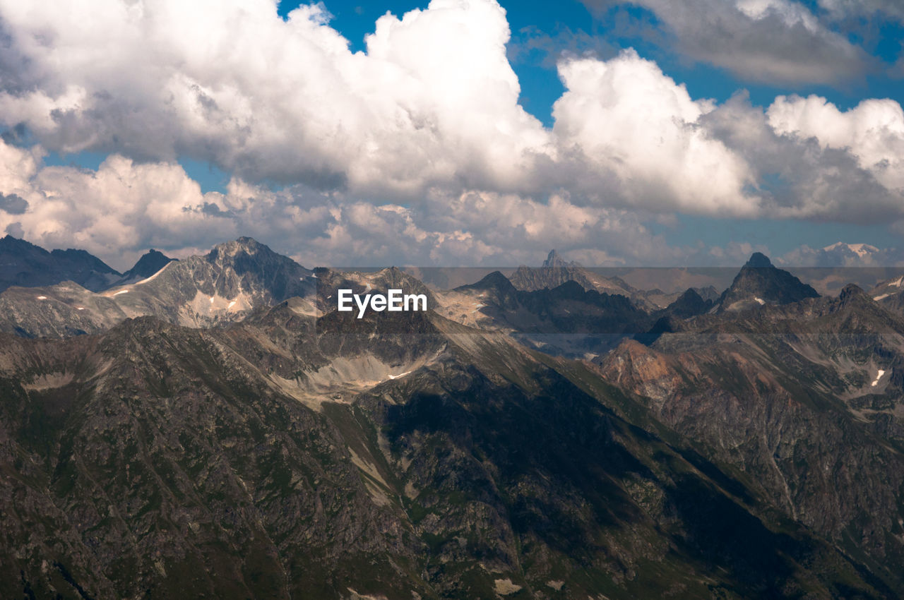 Scenic view of mountains against cloudy sky