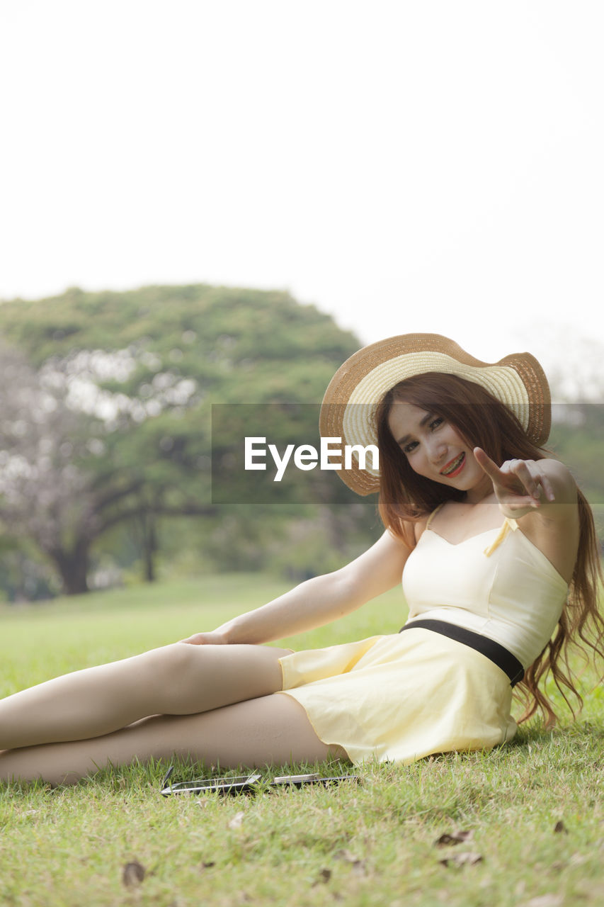 Woman sitting on field at park