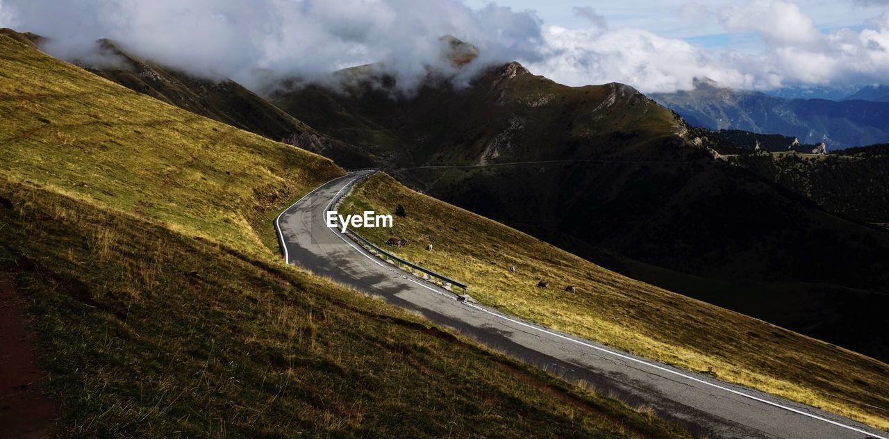 Scenic view of mountains against cloudy sky