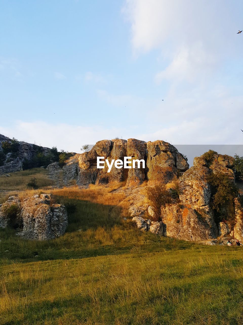 Rock formations on landscape against sky