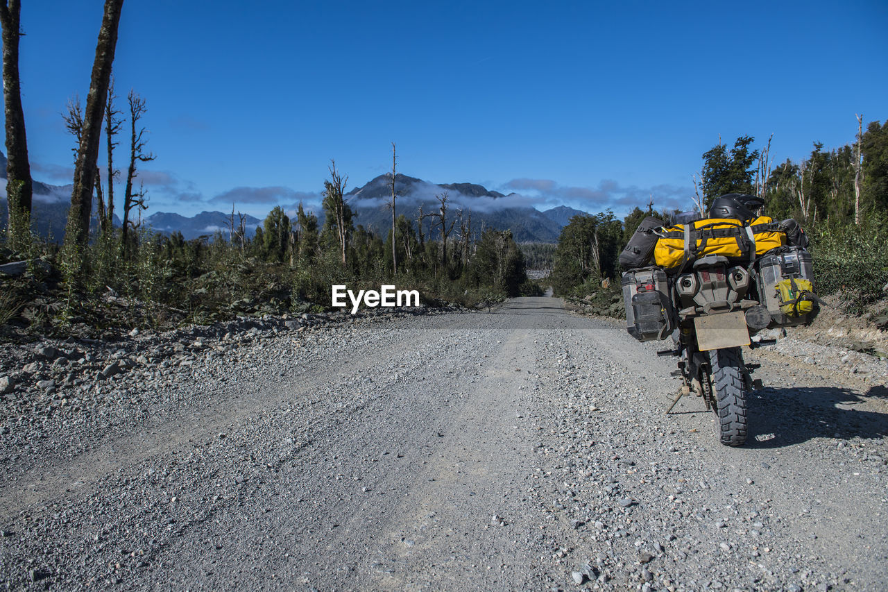 Touring motorbike parked on gravel road on the carretera austral