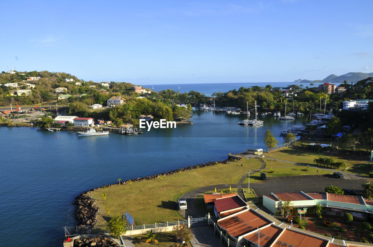 High angle view of townscape by sea against sky