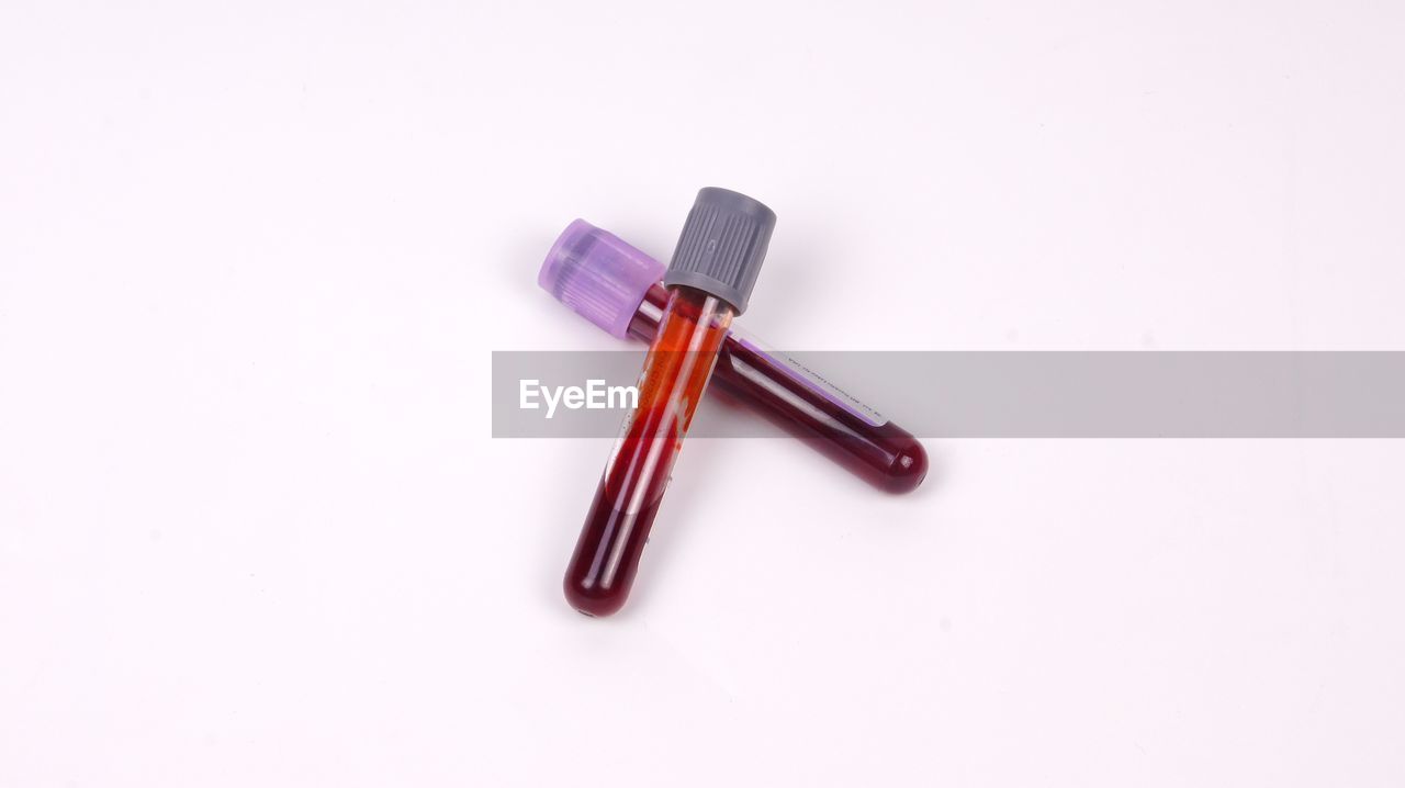 High angle view of blood bottles on white background