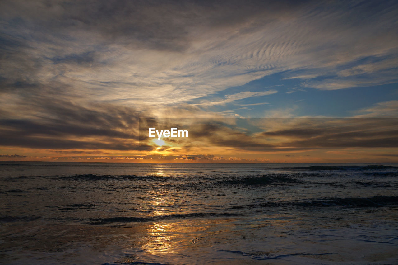 Scenic view of sea against dramatic sky