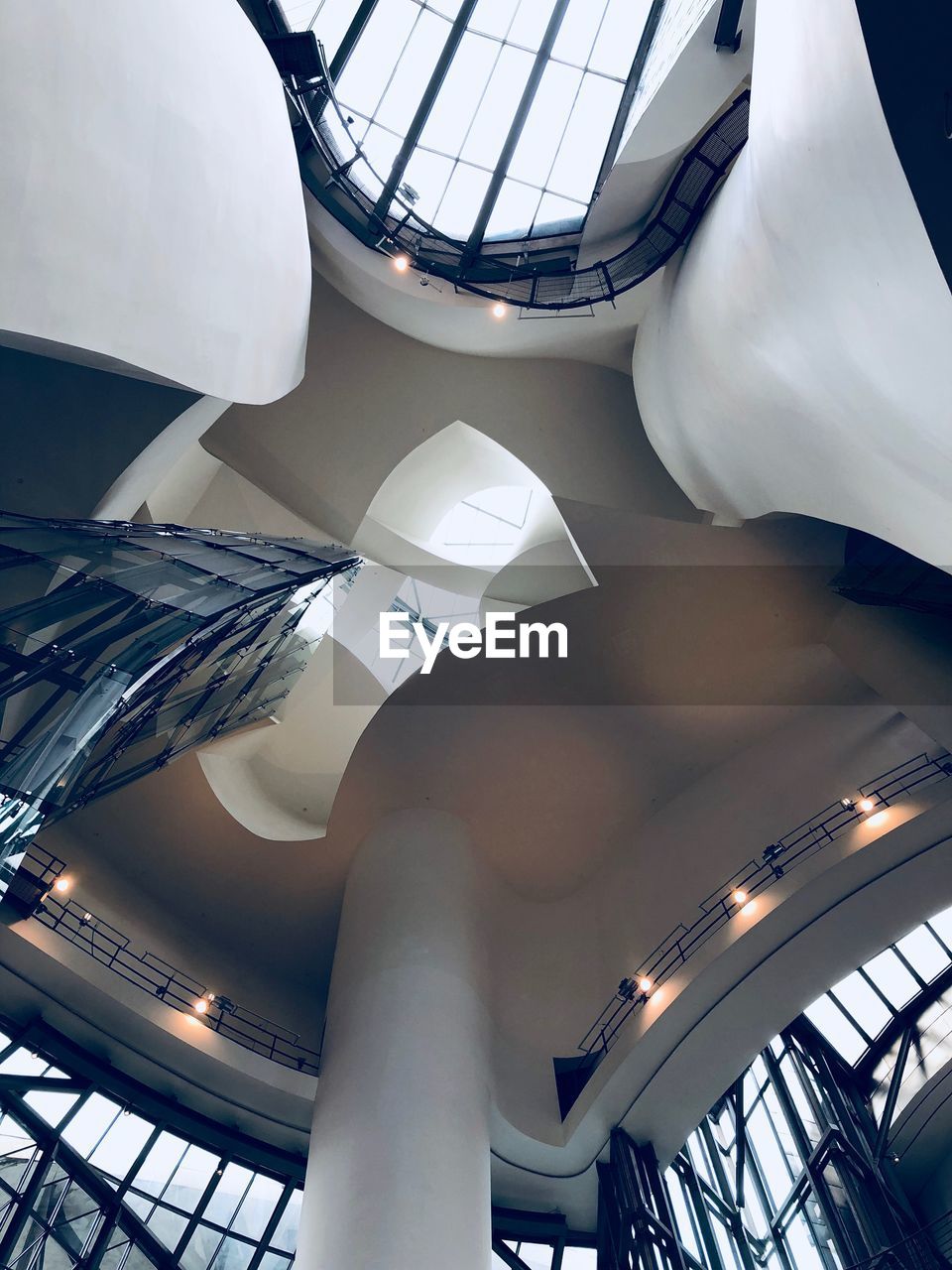 LOW ANGLE VIEW OF SPIRAL STAIRCASE HANGING IN BUILDING