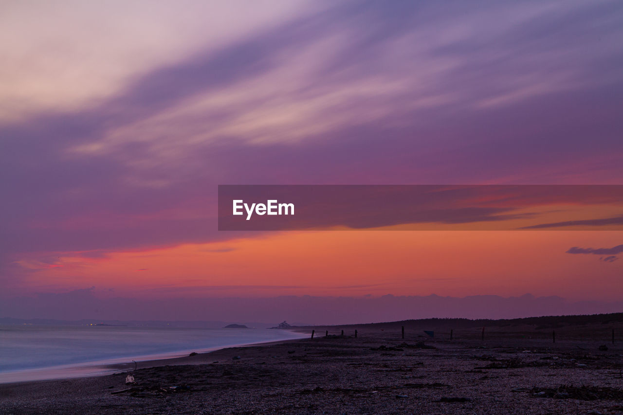 Scenic view of sea against romantic sky at sunset