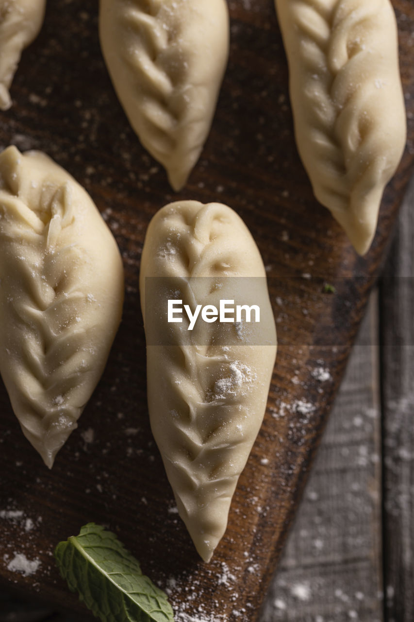 food, food and drink, freshness, indoors, dessert, wood, no people, still life, dish, high angle view, heart shape, wellbeing, preparing food, healthy eating, studio shot, icing, close-up, dough, sweet food, table, raw food, baked, produce, vegetable, kitchen utensil, spice, flour