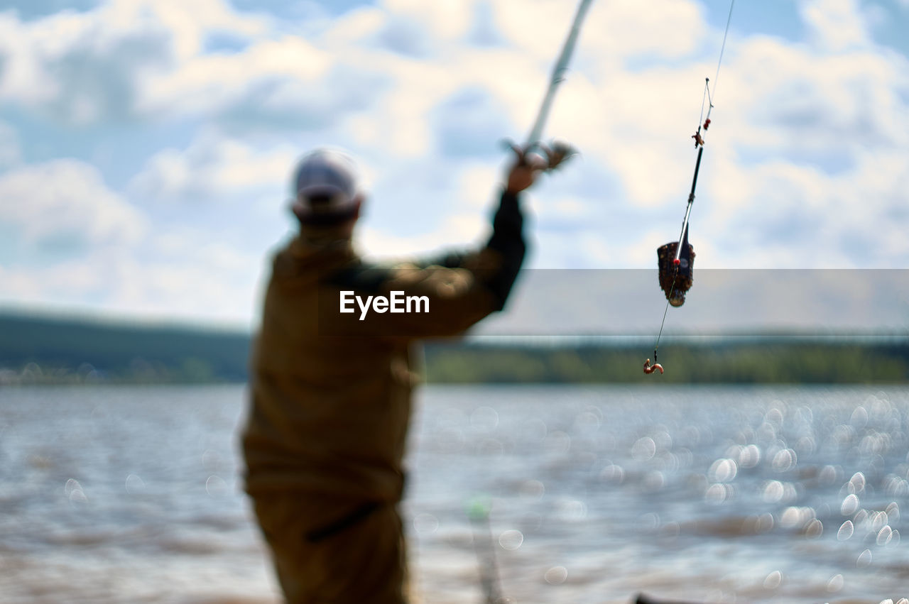 MAN FISHING IN SEA