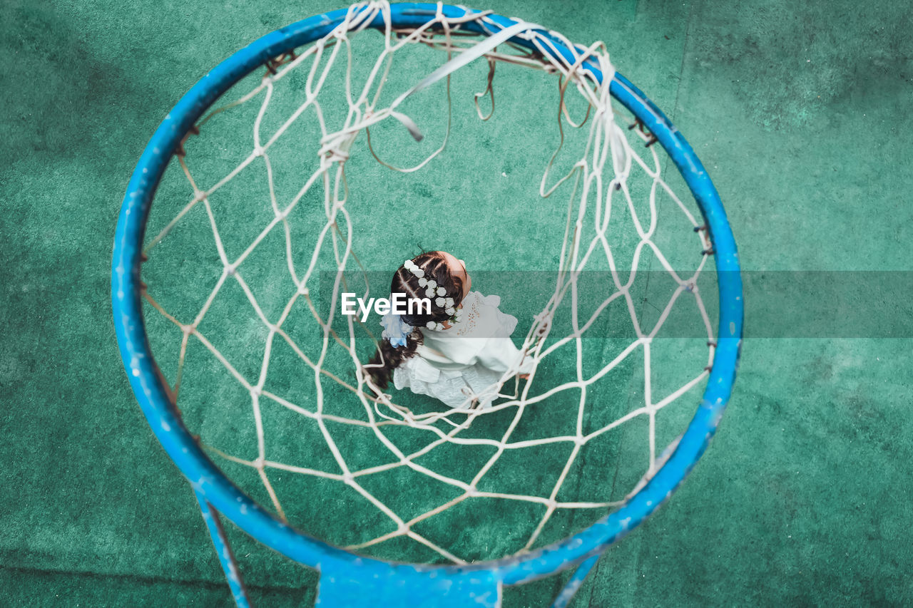 High angle view of girl and basketball hoop