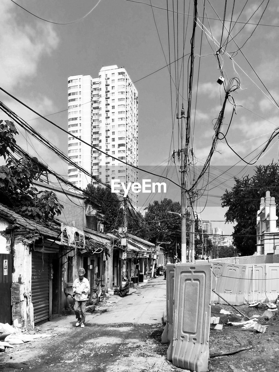 STREET BY BUILDINGS AGAINST SKY