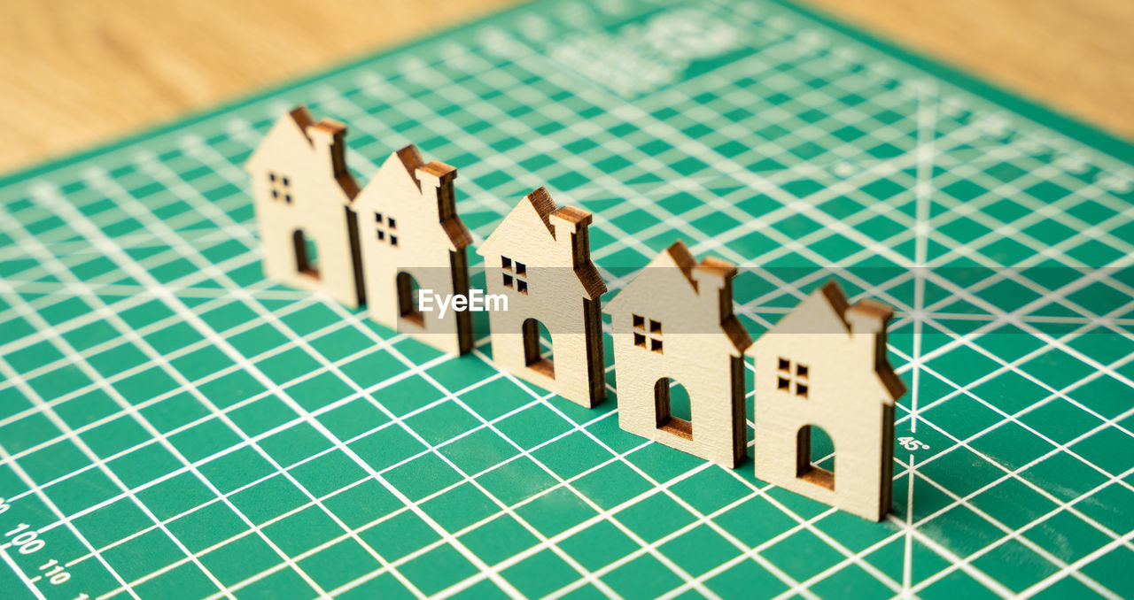 Miniature houses on a cutting mat. home renovation and reconstruction concept