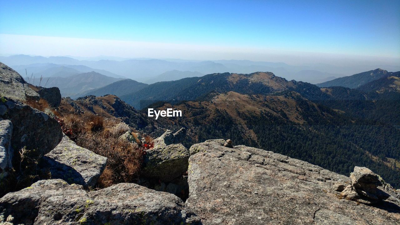 MAN IN MOUNTAINS AGAINST SKY