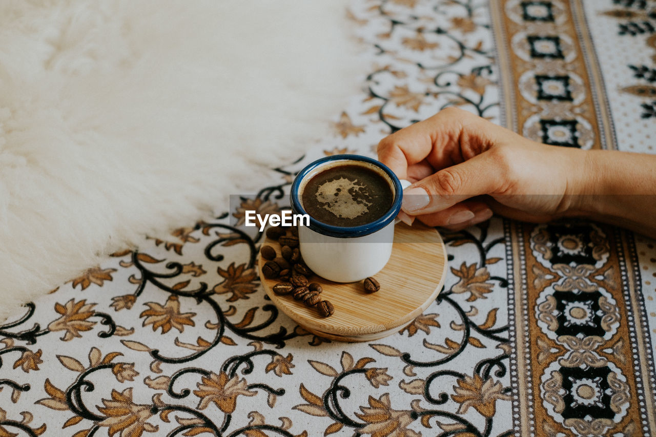 Cropped hand having coffee