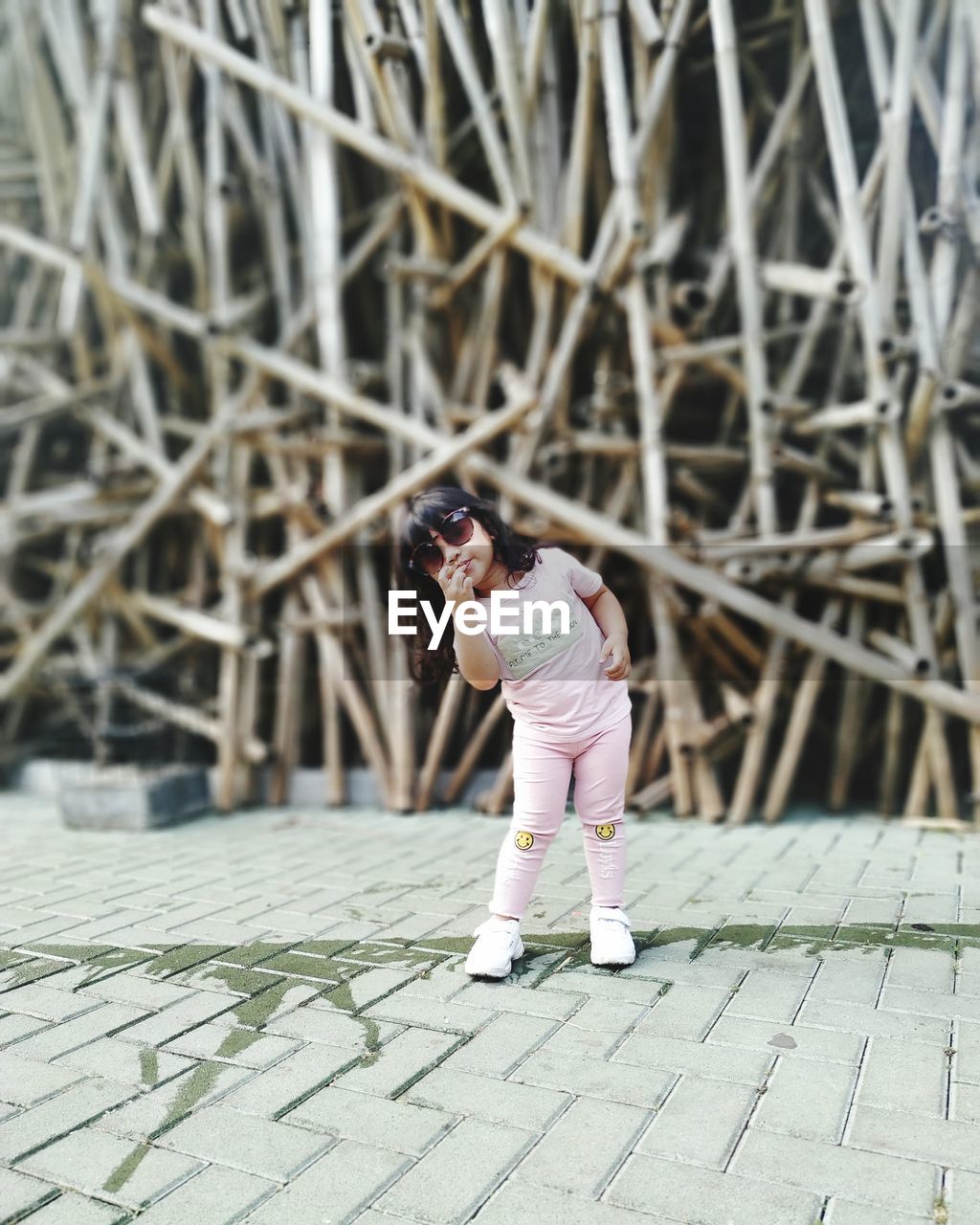 WOMAN STANDING ON FOOTPATH