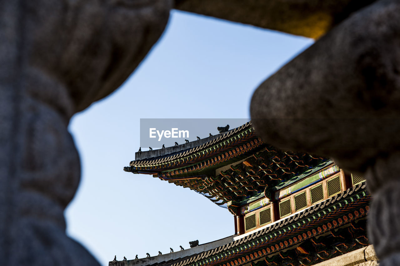 Low angle view of gyeongbokgung roof against clear sky
