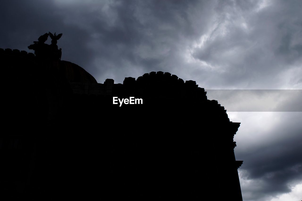 LOW ANGLE VIEW OF SILHOUETTE SCULPTURE AGAINST SKY