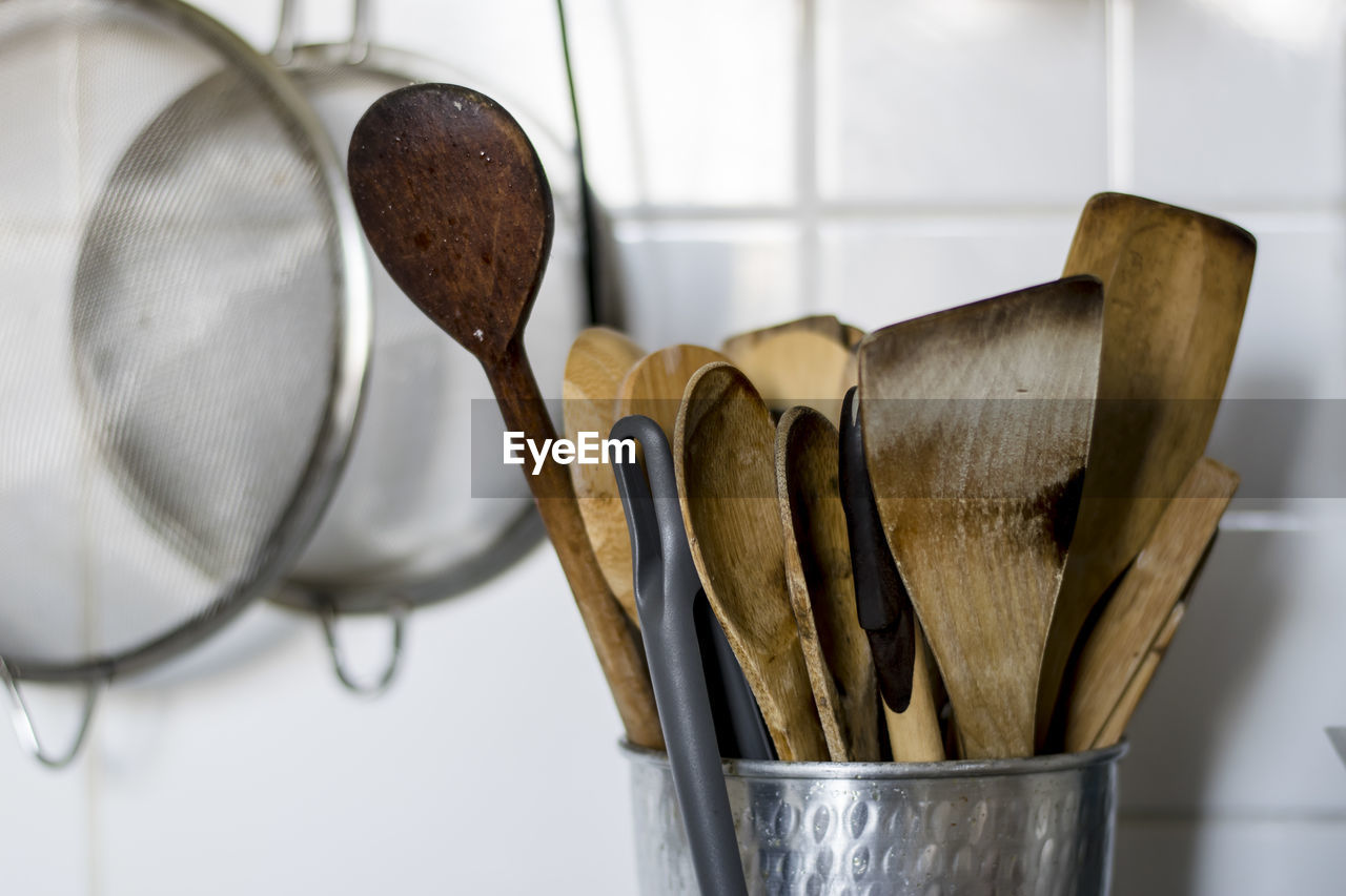 Close-up of wooden kitchen utensils on table