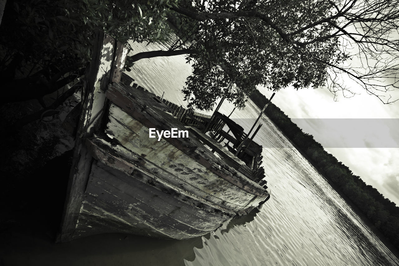 Tilt image of trees by sea against sky