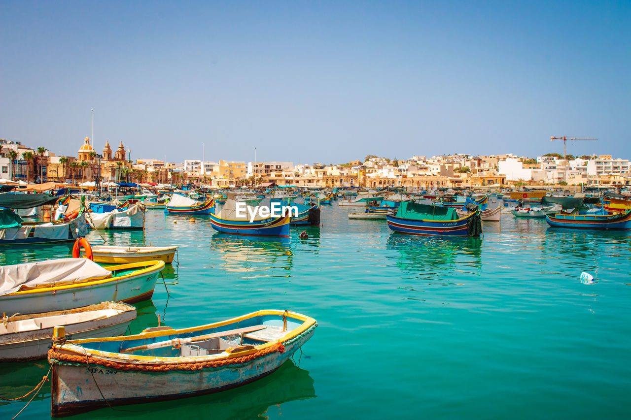 Boats moored at harbor