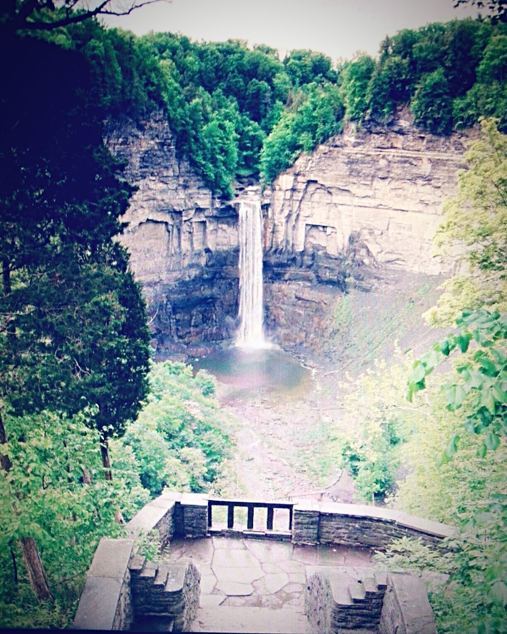 WATERFALL WITH TREES IN BACKGROUND