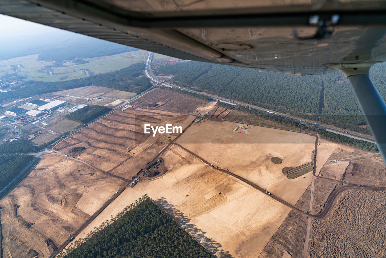 HIGH ANGLE VIEW OF AIRPLANE SEEN THROUGH VEHICLE WINDOW