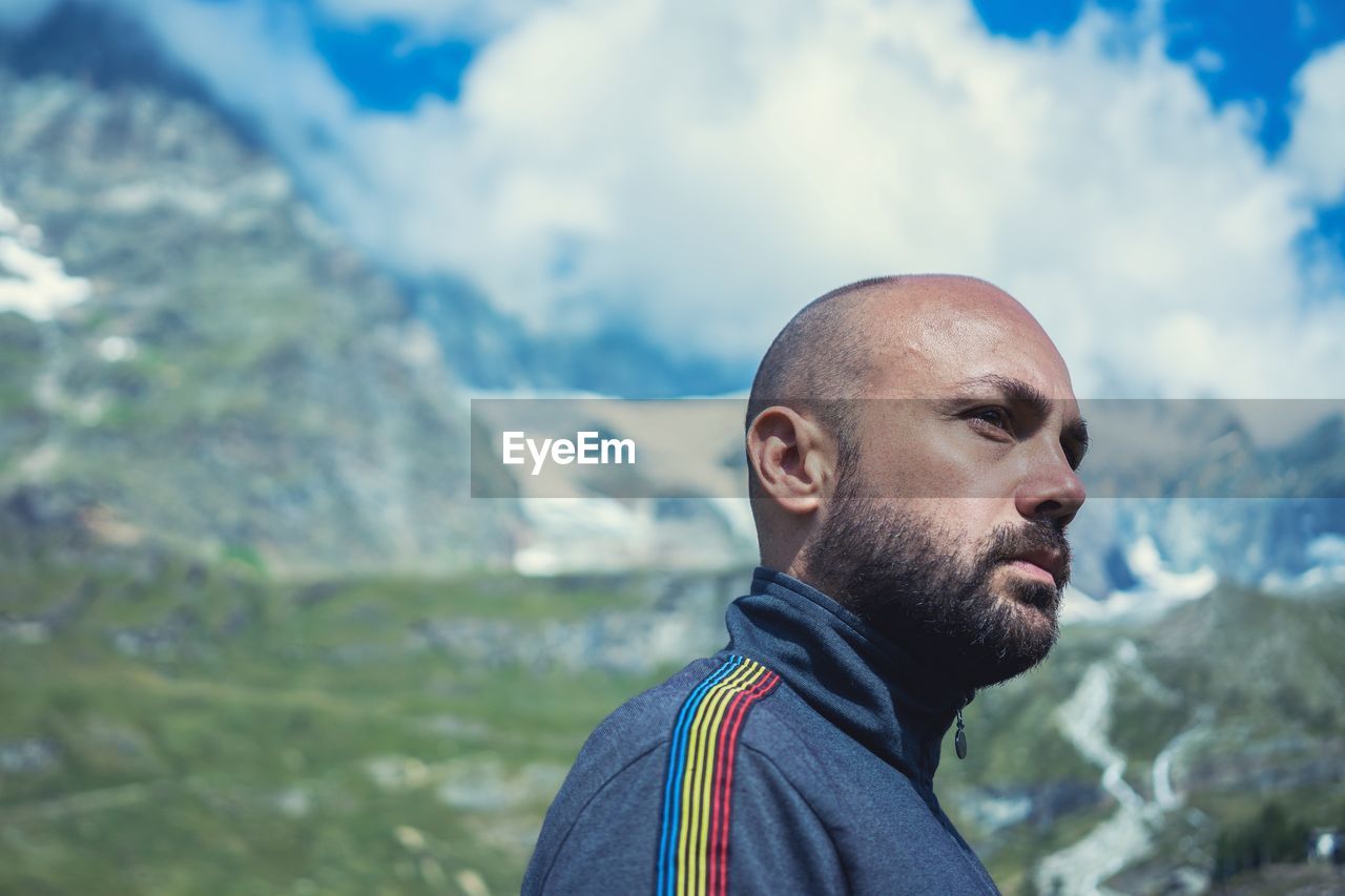 Close-up of man standing against mountains