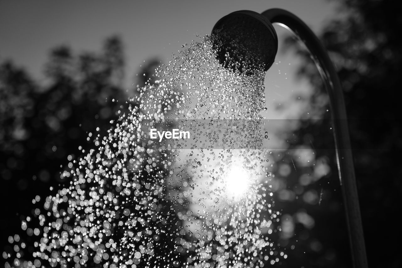 Water spraying through shower outdoors