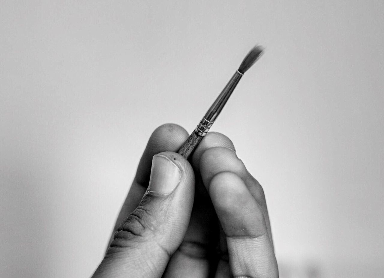 CLOSE-UP OF HUMAN HAND HOLDING WHITE BACKGROUND