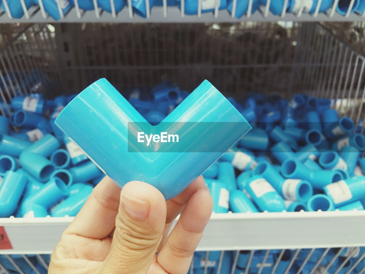 Cropped image of hand holding plastic equipment