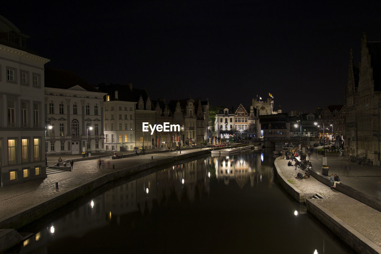 Reflection of gent by  water at night