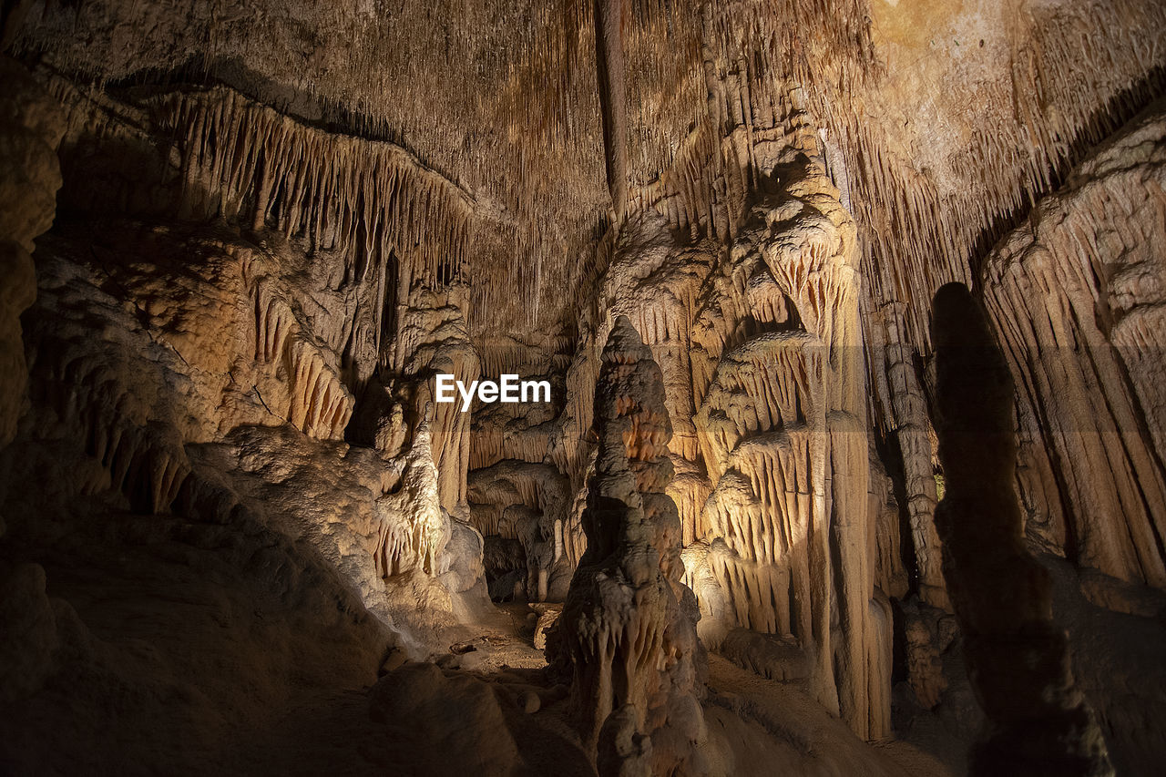 LOW ANGLE VIEW OF ROCK FORMATIONS AT CAVE