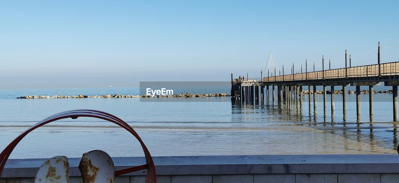 Pier over sea against clear sky