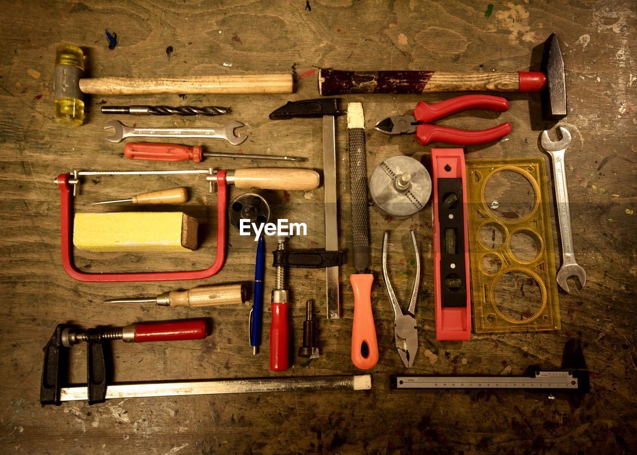 High angle view of various tools on table at workshop