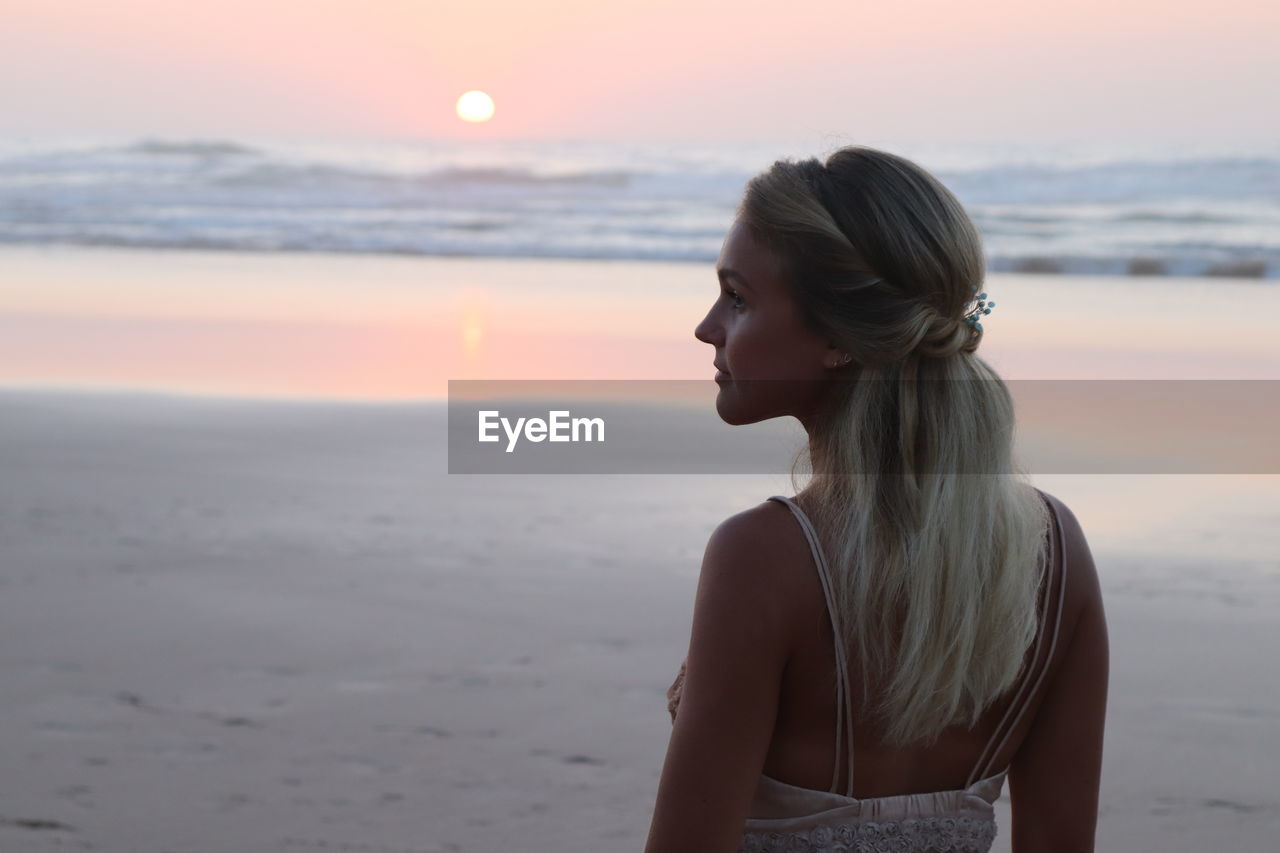 Woman at beach during sunset