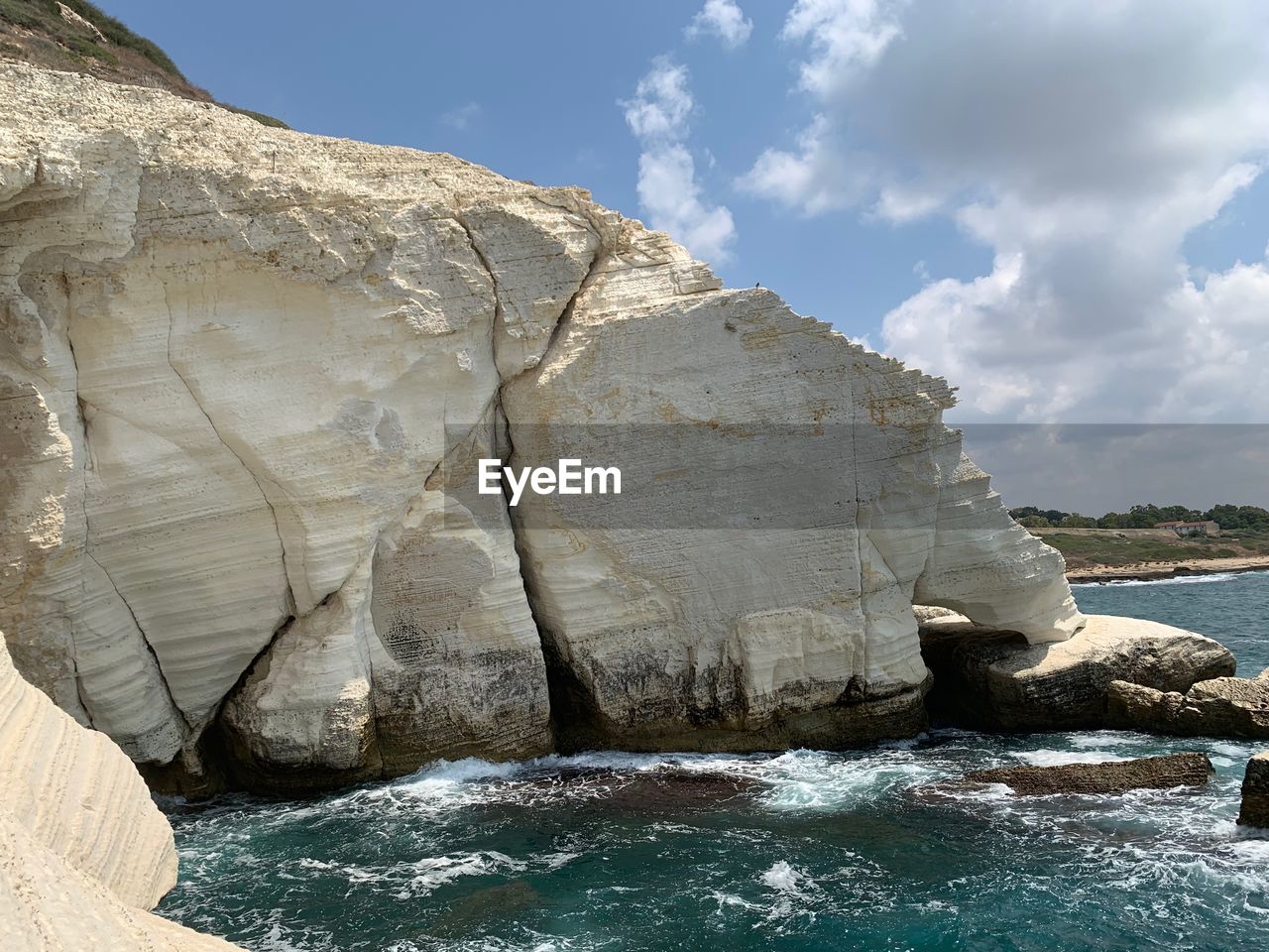 Rock formation in sea against sky