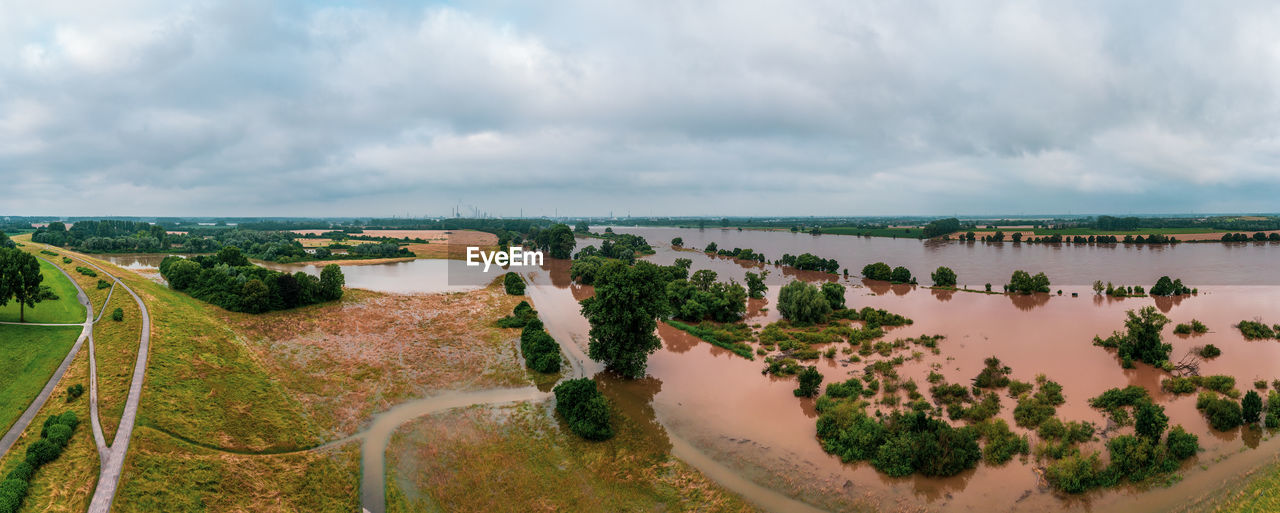 water, environment, sky, cloud, landscape, nature, land, scenics - nature, plant, panoramic, river, coast, travel, beauty in nature, travel destinations, architecture, no people, tree, aerial photography, tourism, tranquility, outdoors, beach, rural area, shore, city, reservoir, waterway, day, rural scene, transportation, road, building, aerial view, overcast, tranquil scene, wetland, social issues, built structure, agriculture, high angle view, horizon, environmental conservation, coastline