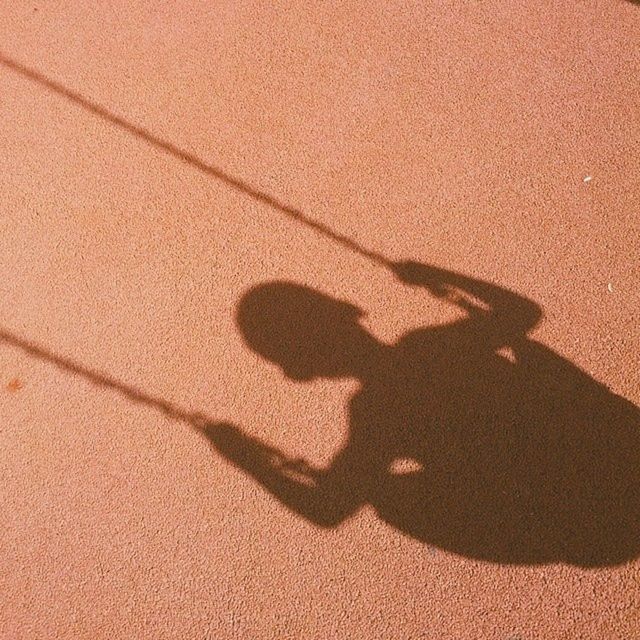 Shadow on a boy swinging