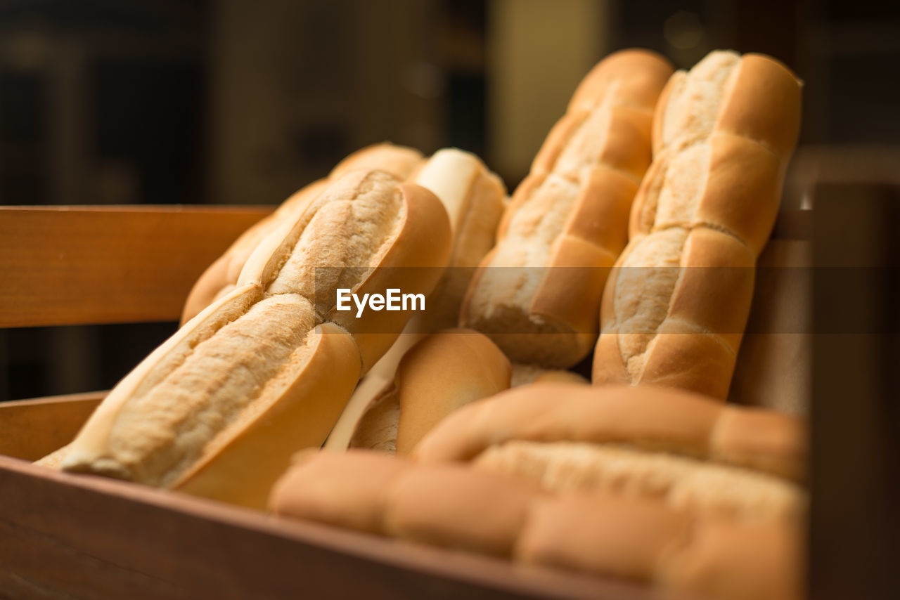 Close-up of baguettes in crate for sale at bakery