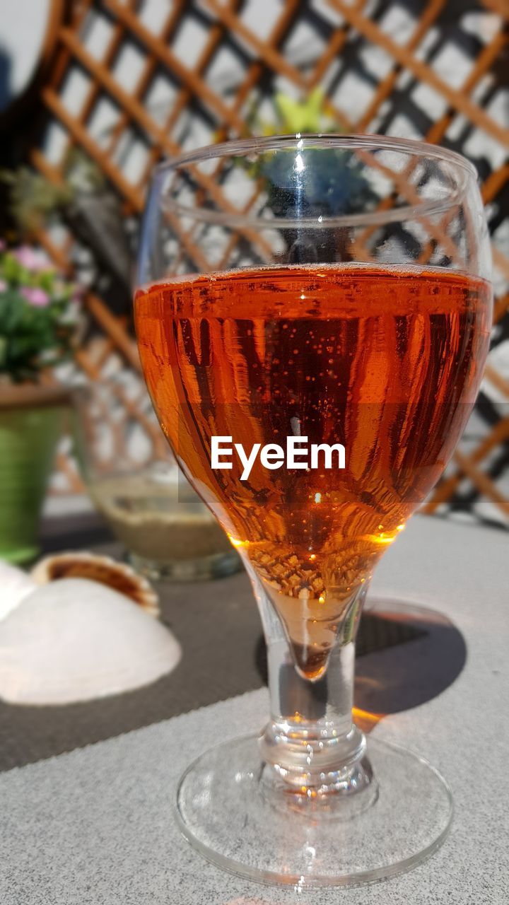 Close-up of orange aperitif in glass on table