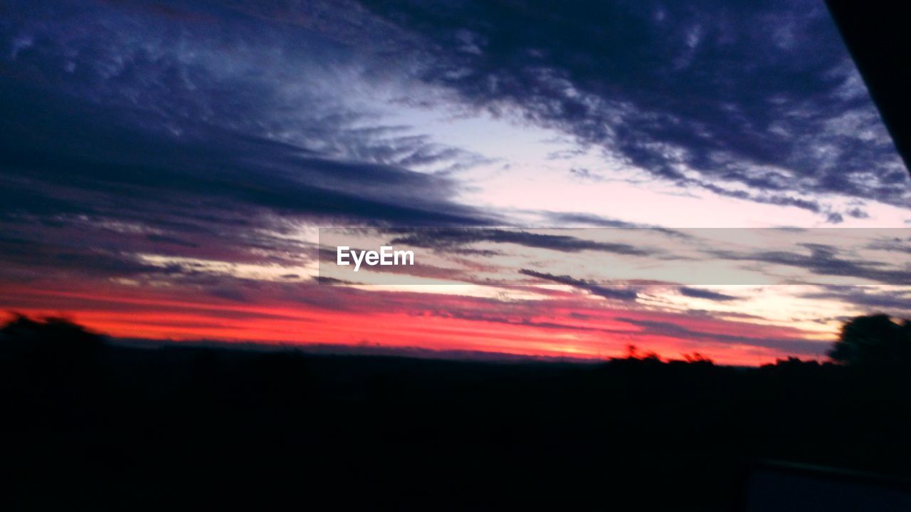 SILHOUETTE OF LANDSCAPE AGAINST CLOUDY SKY