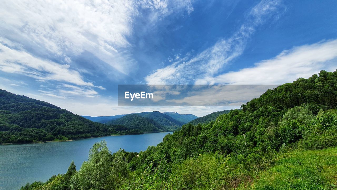 Scenic view of lake and mountains against sky