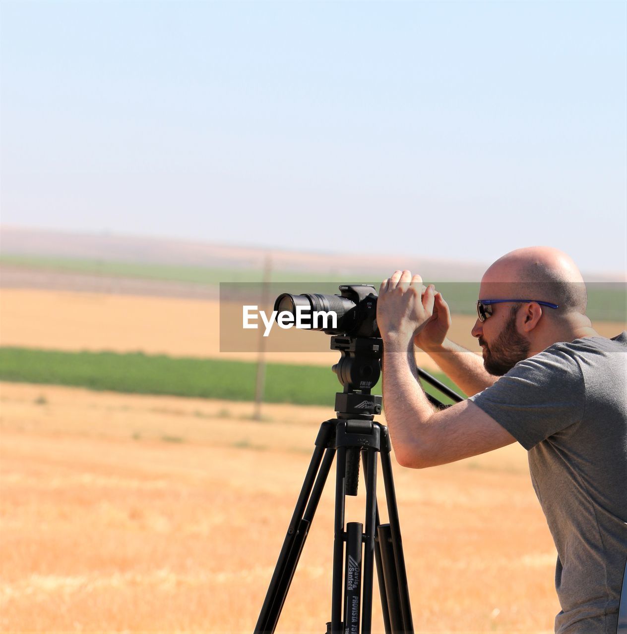 MAN PHOTOGRAPHING ON CAMERA